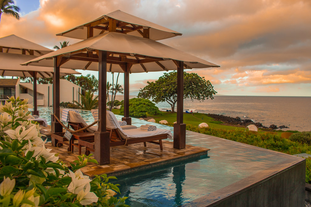 infinity pool cabana with view of ocean